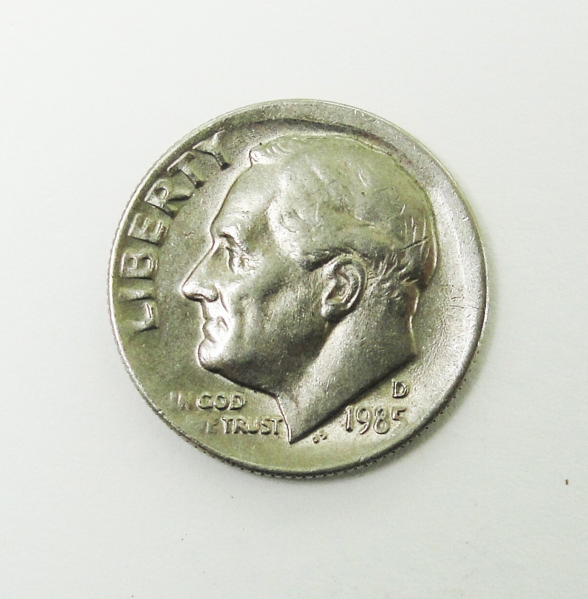 1985 dime off-center strike error showing design shifted and blank crescent planchet area