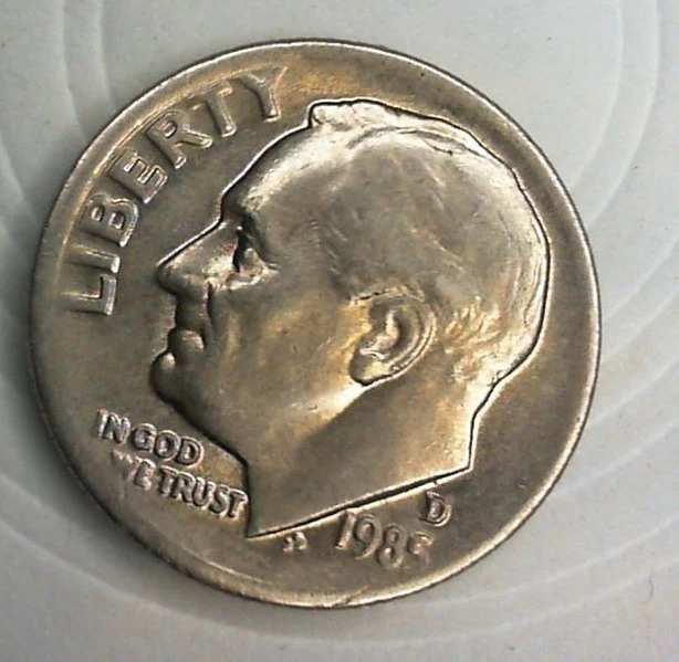 1985 dime struck-through grease error showing missing design detail on obverse